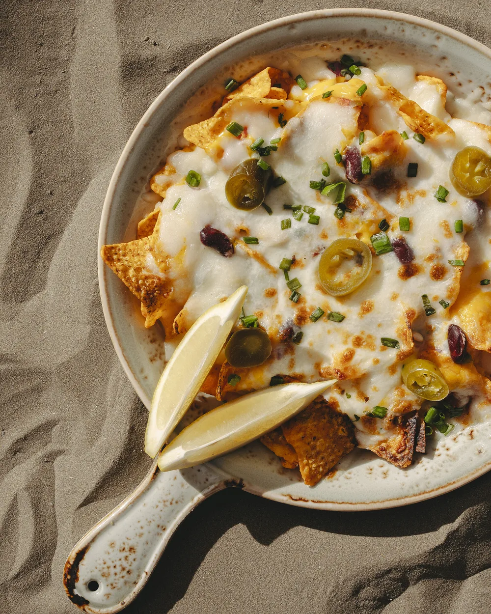 Nachos with cheese and jalapeño — right on the sand